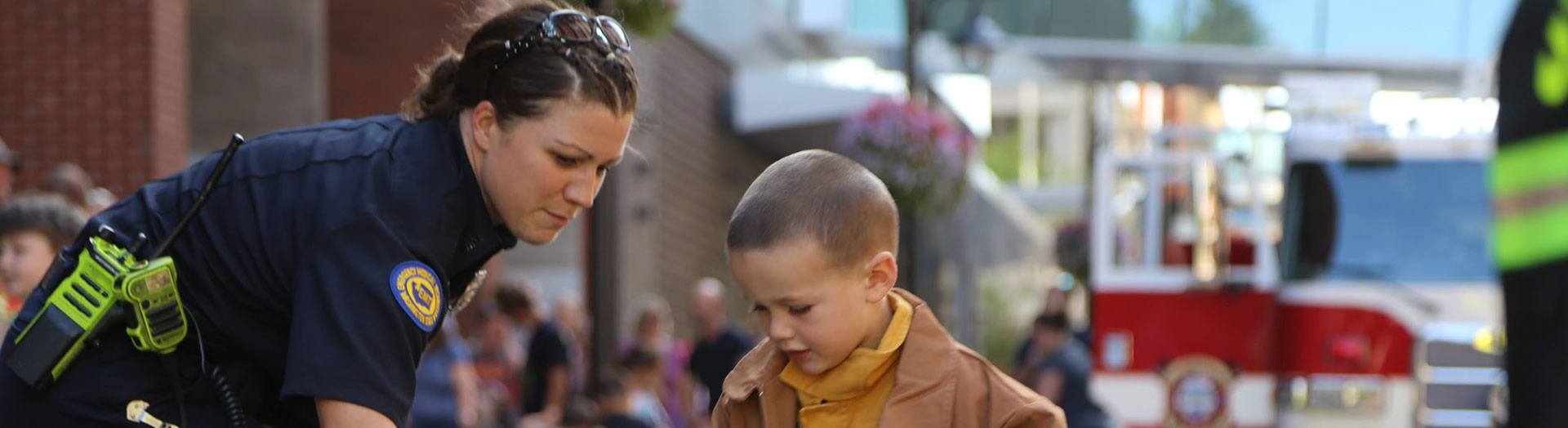 Female firefighter header teaching boy